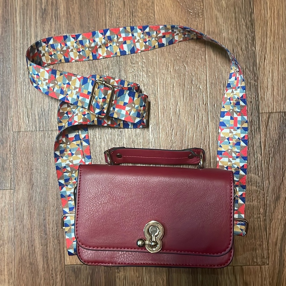 Small red purse with thick colorful strap